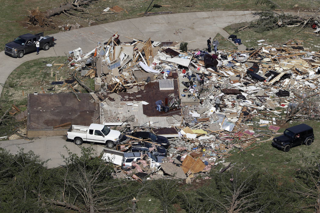 People begin cleaning up Tuesday, March 3, 2020, near Cookeville, Tenn. Deadly tornadoes ripped ...