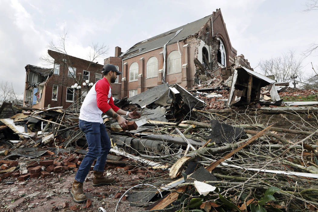 Sumant Joshi helps to clean up rubble at the East End United Methodist Church after it was heav ...