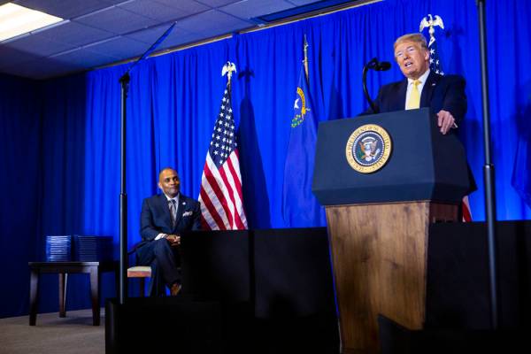 President Donald Trump speaks as Hope for Prisoners CEO Jon Ponder, left, looks on during a gra ...