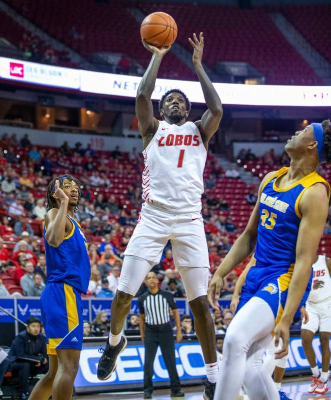 New Mexico Lobos forward Corey Manigault (1) looks to shoot between the San Jose State Spartans ...