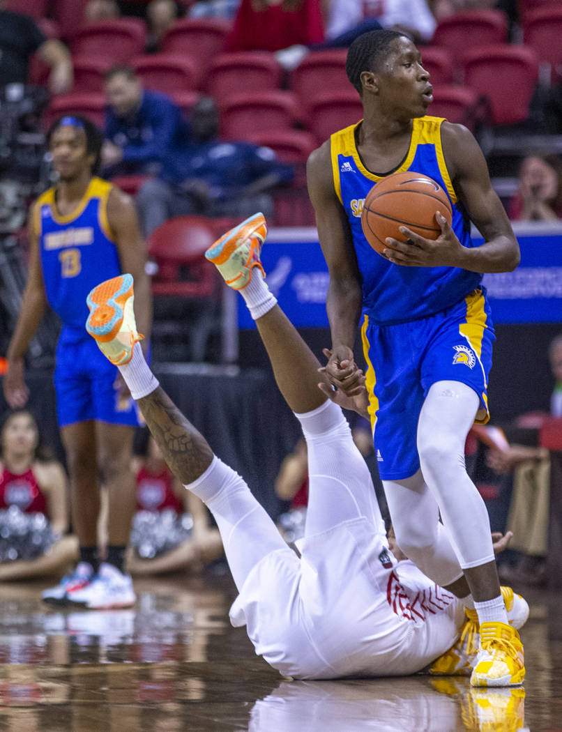 San Jose State Spartans guard Omari Moore (10, above) looks for the foul call as New Mexico Lob ...