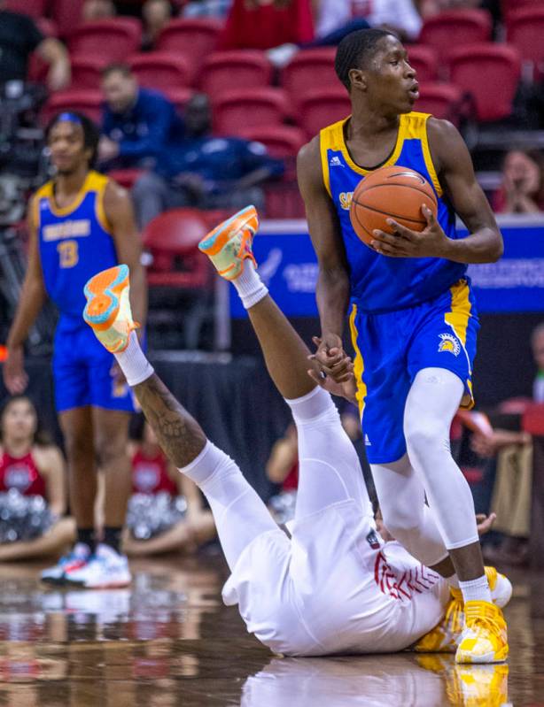 San Jose State Spartans guard Omari Moore (10, above) looks for the foul call as New Mexico Lob ...