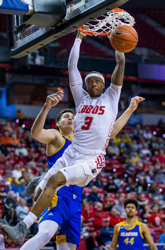 New Mexico Lobos guard Keith McGee (3, right) dunks after beating San Jose State Spartans forwa ...