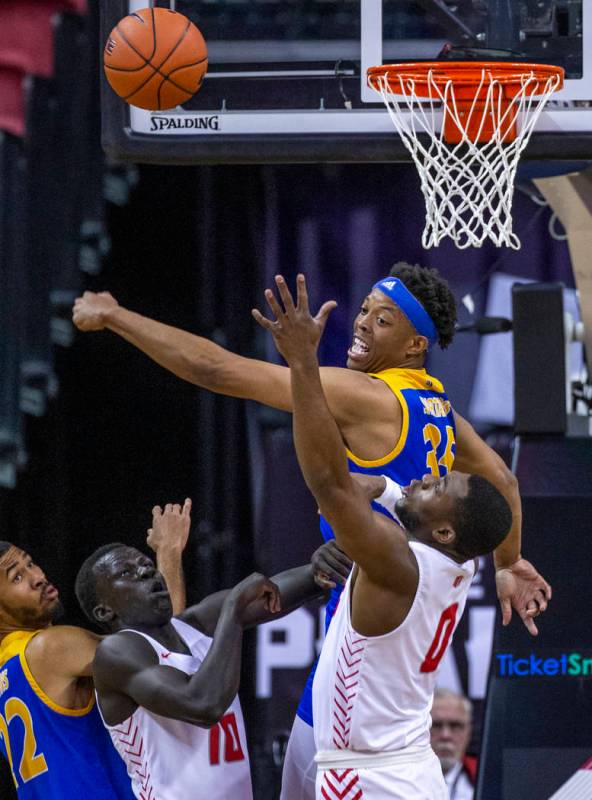 San Jose State Spartans forward Ralph Agee (35, above) swats away a shot by New Mexico Lobos gu ...