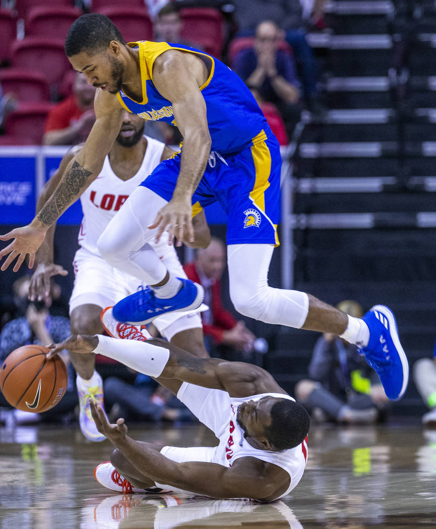 San Jose State Spartans guard Richard Washington (22, above) leaps toward a loose ball from New ...