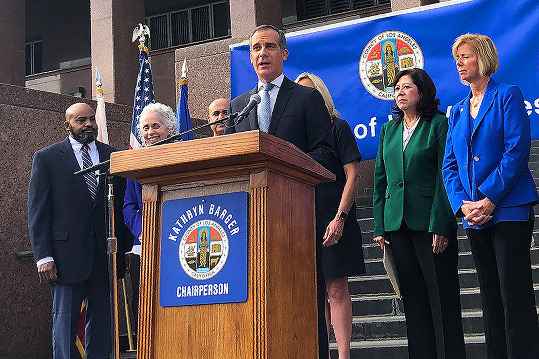 Los Angeles Mayor Eric Garcetti speaks at a news conference that announced that six new cases o ...