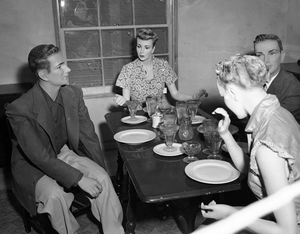 Mannequins seated at a table in the dining room of house number two, attend a "dinner part ...
