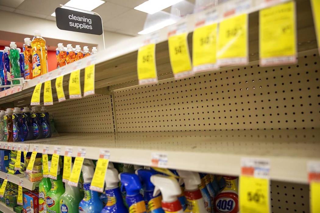 Shelves where disinfectant wipes and sprays are usually displayed sit empty in a pharmacy Wedne ...