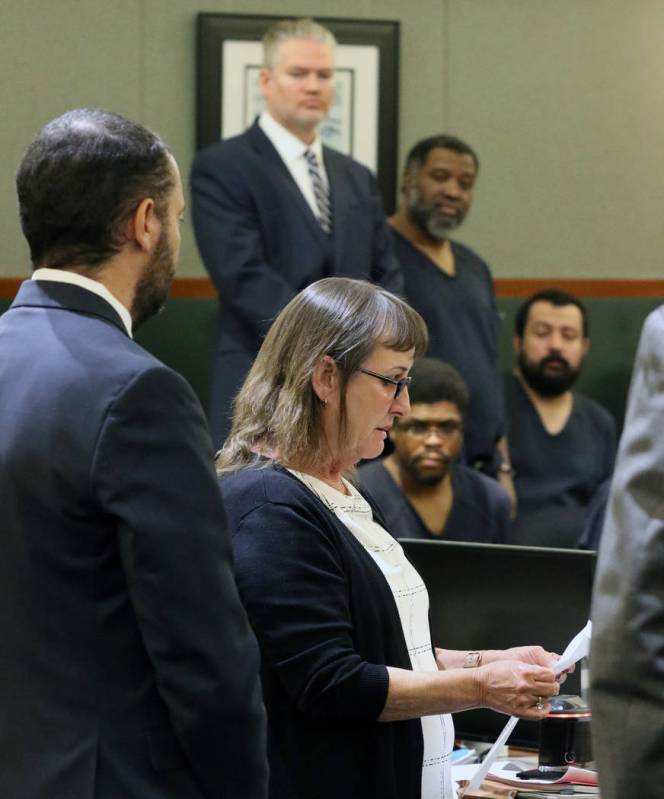 Alice Garcia, center, a sister of murder victim Kelly Deanne Kazoon, 55, reads her victim impac ...