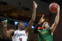 Chicago State senior guard Rob Shaw (1) slices to the rim past New Mexico State junior guard Te ...