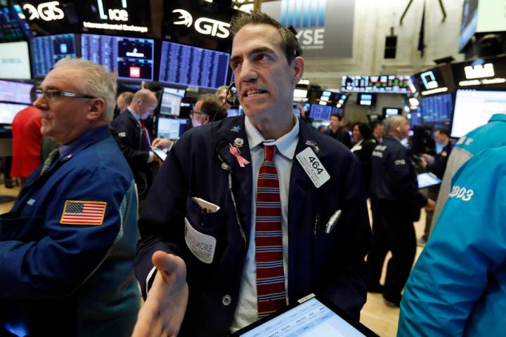 Trader Gregory Rowe, center, works on the floor of the New York Stock Exchange, Thursday, March ...