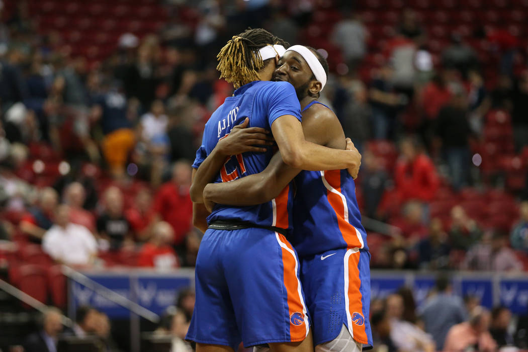 Boise State Broncos guard Derrick Alston (21) and forward RJ Williams (23) embrace after their ...
