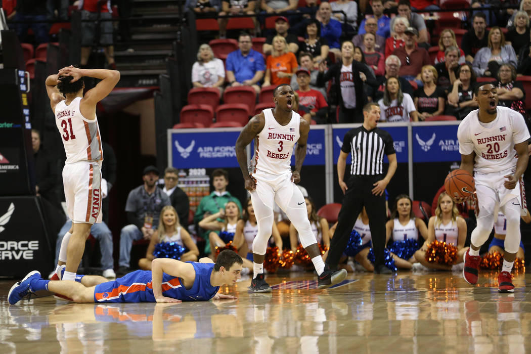 UNLV Rebels guard Marvin Coleman (31), guard Amauri Hardy (3) and forward Nick Blair (20) react ...