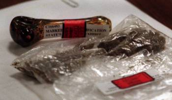 A pipe and a bag of marijuana that was found in the Jessica Williams van lays on the distinct a ...