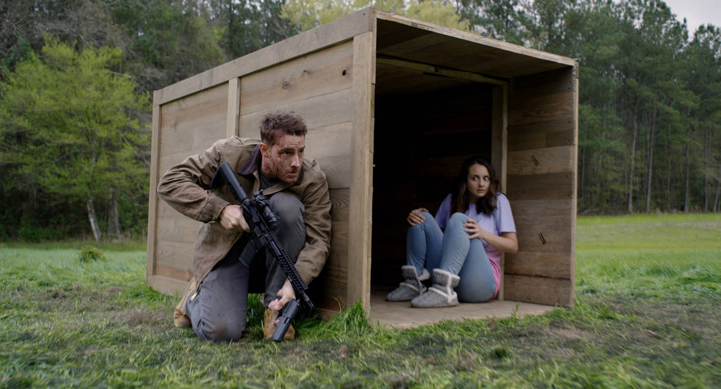 Members of the hunted (from left, Justin Hartley, Sylvia Grace Crim) in The Hunt, directed by C ...