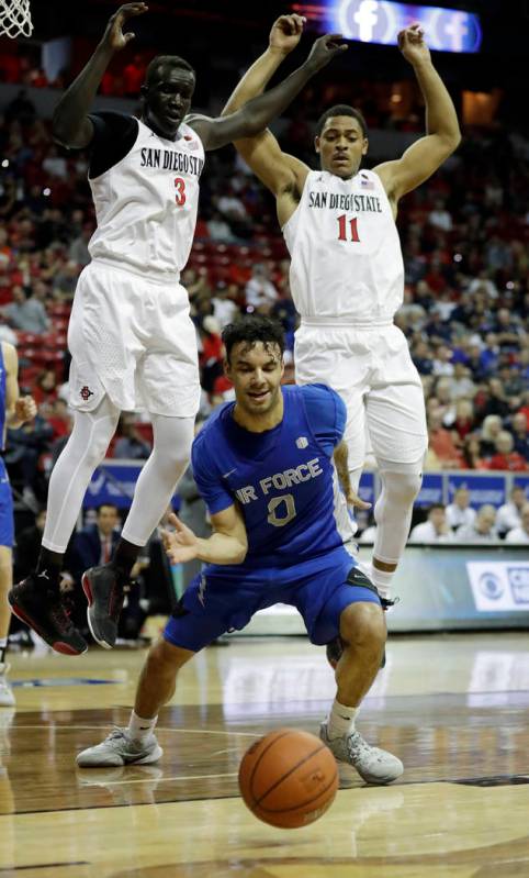 Air Force's Caleb Morris (0) reaches for a loose ball as San Diego State's Aguek Arop (3) and M ...