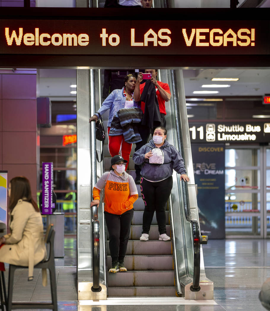 Passengers Sherry Carter, left, and Kimberly Thompson of Virginia wear face masks while arrivin ...