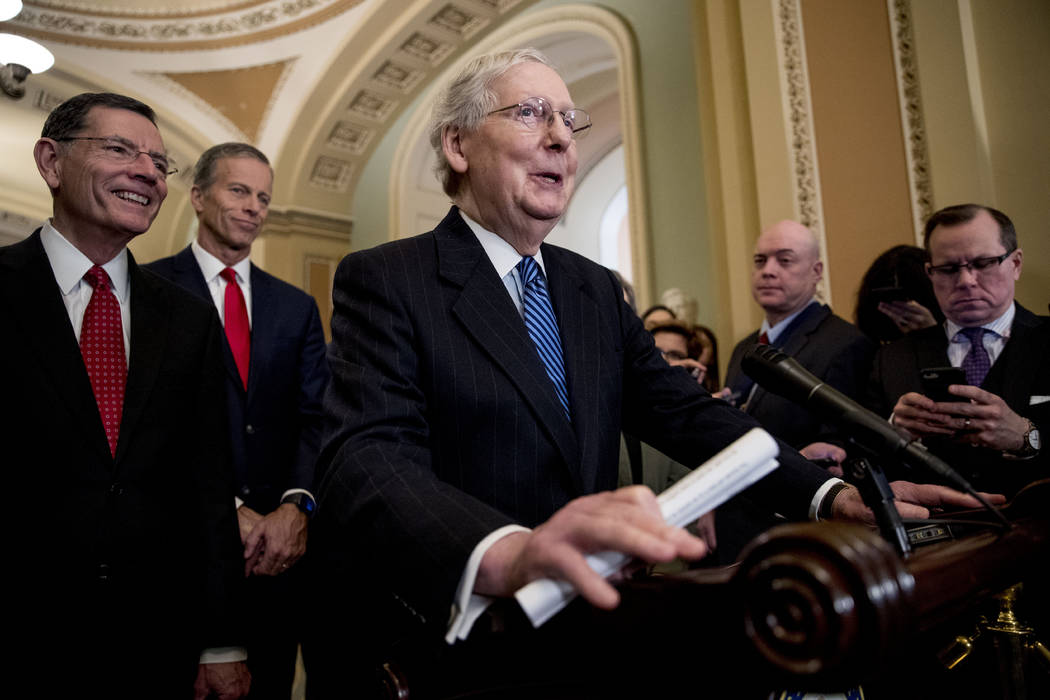 Senate Majority Leader Mitch McConnell of Ky., center, accompanied by Sen. John Barrasso, R-Wyo ...