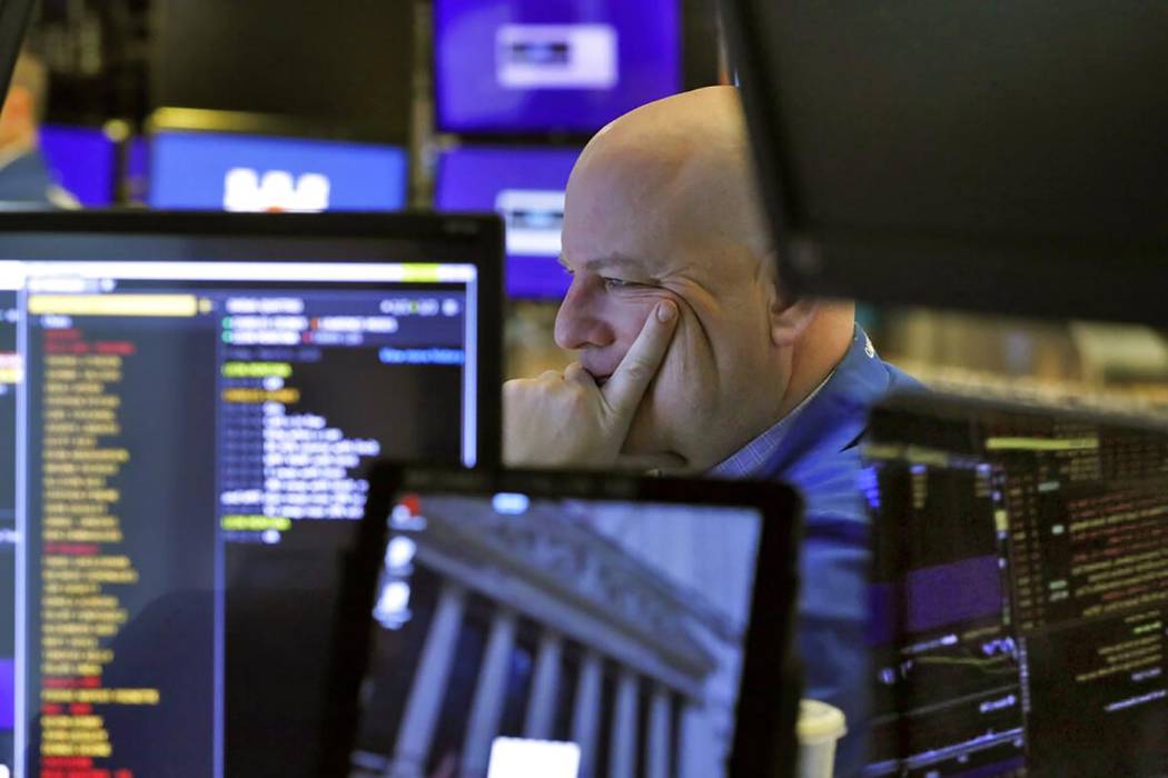 A trader studies his screens as he prepares for the day's activities on the floor of the New Yo ...