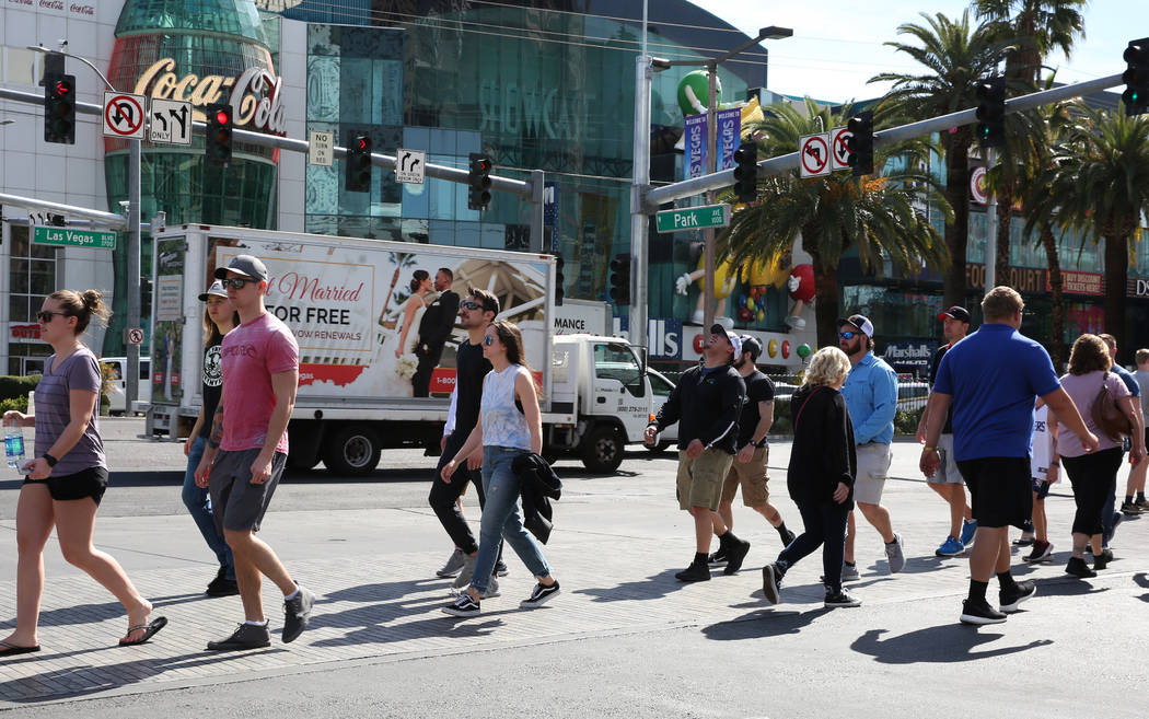 Tourists walk along Las Vegas Boulevard on Friday, March 6, 2020, in Las Vegas. (Bizuayehu Tesf ...