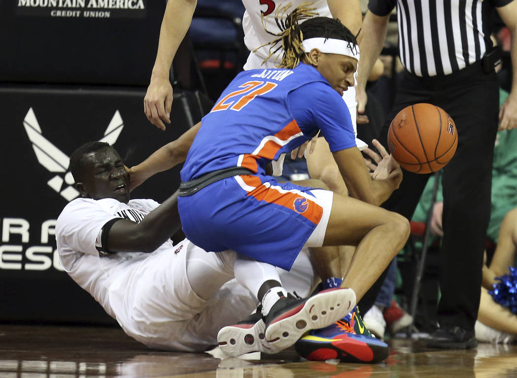 Boise State's Derrick Alston (21) and San Diego State's Aguek Arop (3) become entangled during ...
