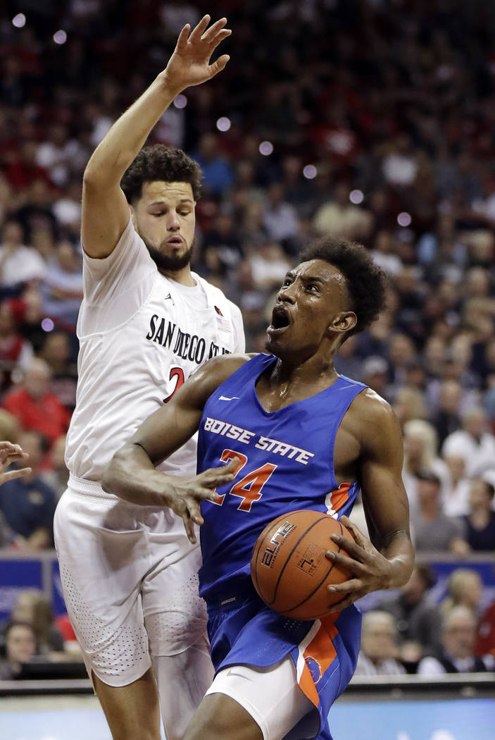 Boise State's Abu Kigab drives as San Diego State's Jordan Schakel defends during the first hal ...
