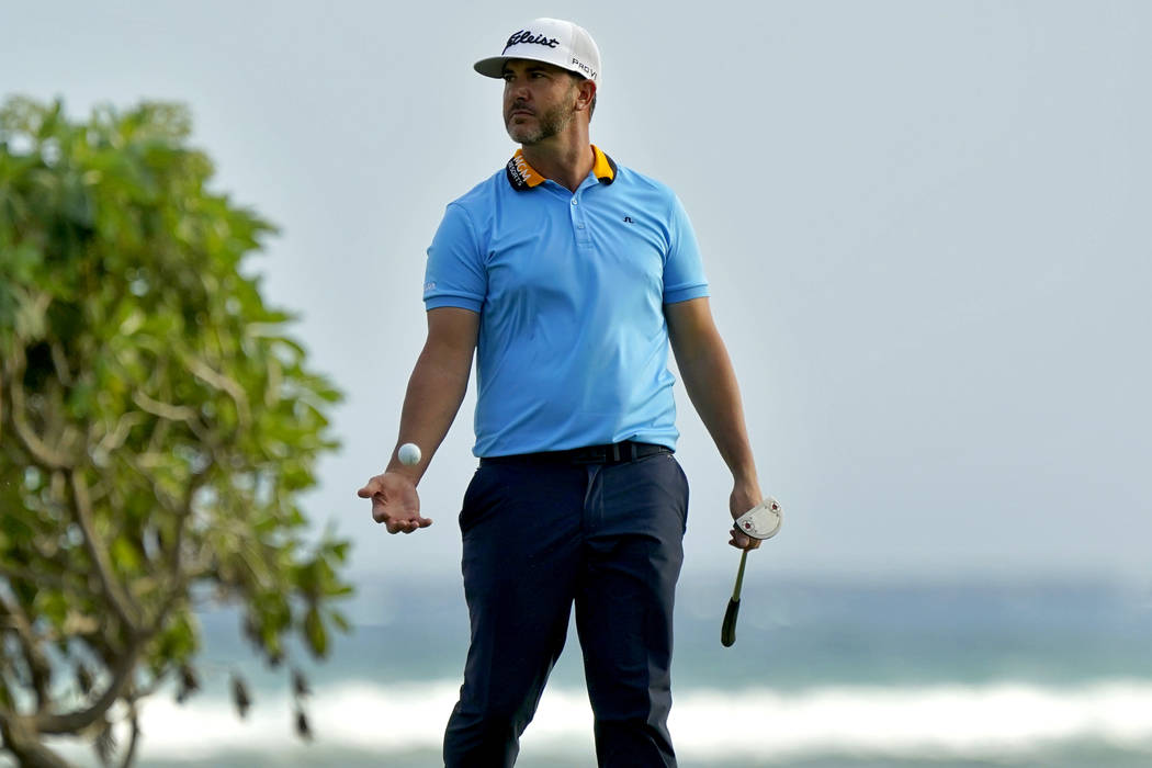 Scott Piercy tosses his ball after missing his birdie putt on the 16th green during the first r ...