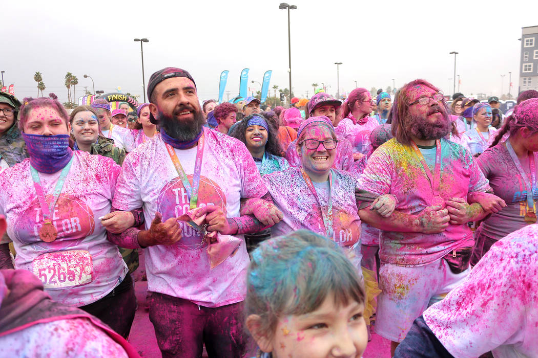 Color Run participants link arms and dance to music at the end of the run. (Anton)