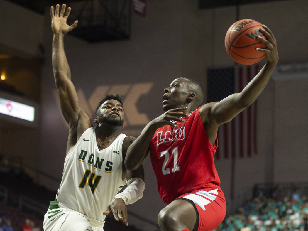 Loyola Marymount Lions guard Seikou Sisoho Jawara (21) drives past San Francisco Dons guard Cha ...