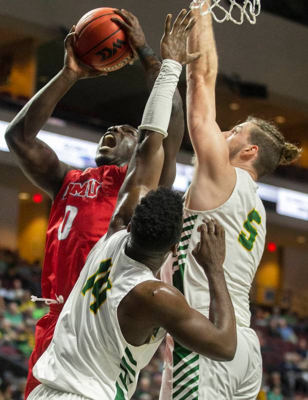 Loyola Marymount Lions guard Eli Scott (0) drives past San Francisco Dons guard Charles Minlend ...