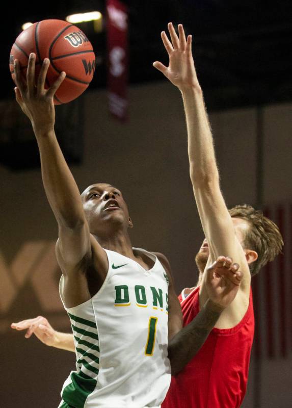 San Francisco Dons guard Jamaree Bouyea (1) slices to the rim past Loyola Marymount Lions guard ...