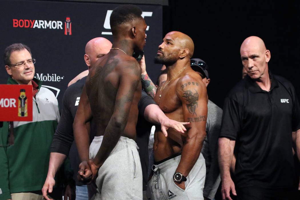 UFC middleweight champion Israel Adesanya, left, faces off against title challenger, Yoel Romer ...