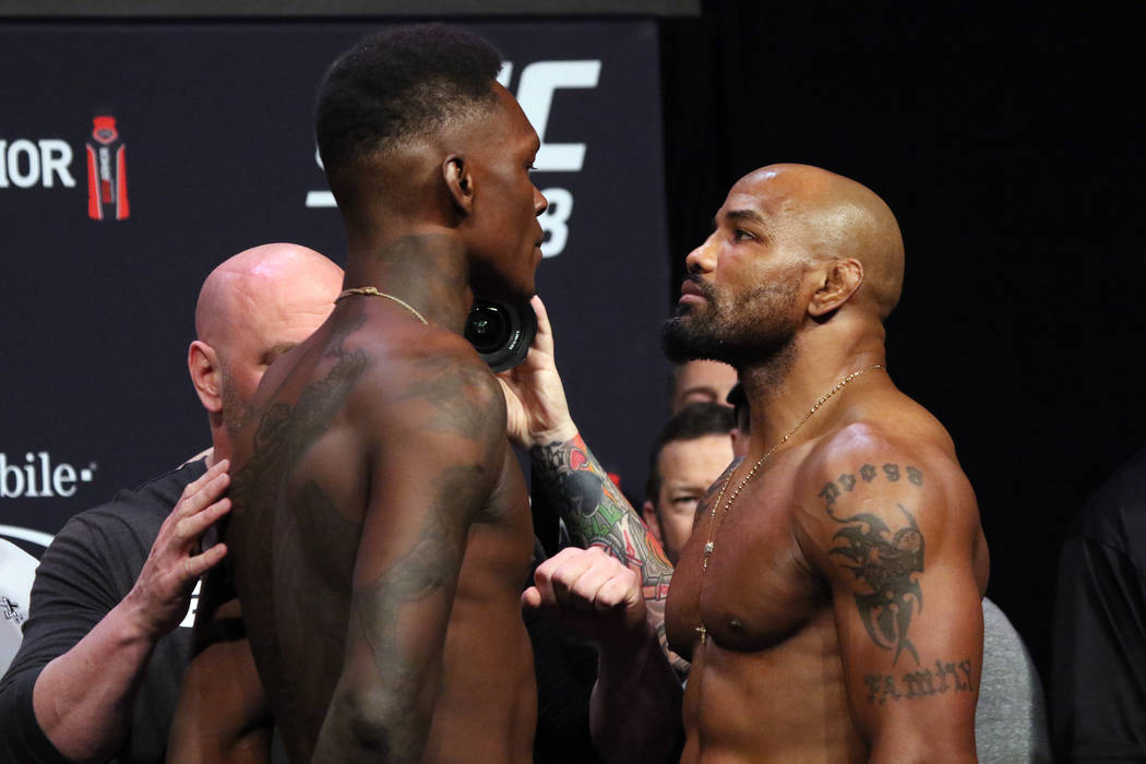 UFC middleweight champion Israel Adesanya, left, faces off against title challenger, Yoel Romer ...