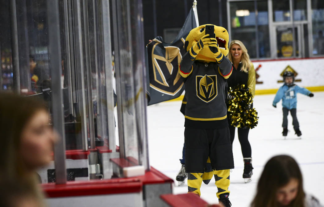 Golden Knights mascot Chance takes a selfie during an away game against the Winnipeg Jets with ...