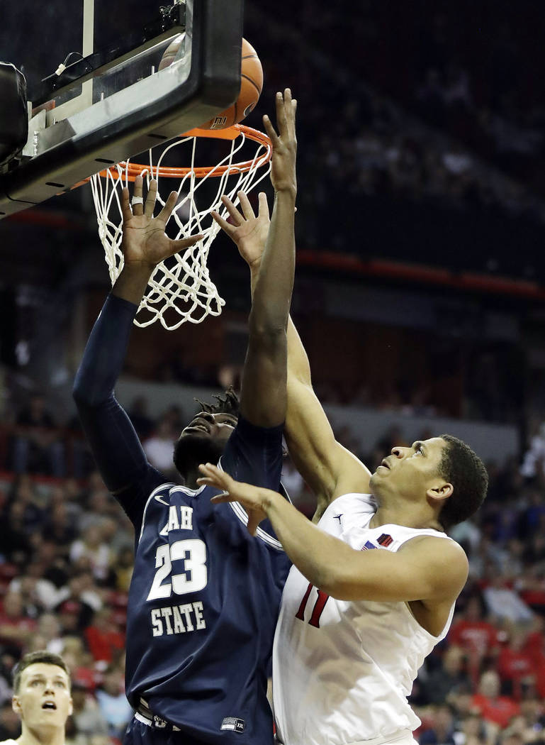 San Diego State's Matt Mitchell (11) and Utah State's Neemias Queta (23) reach for a rebound du ...