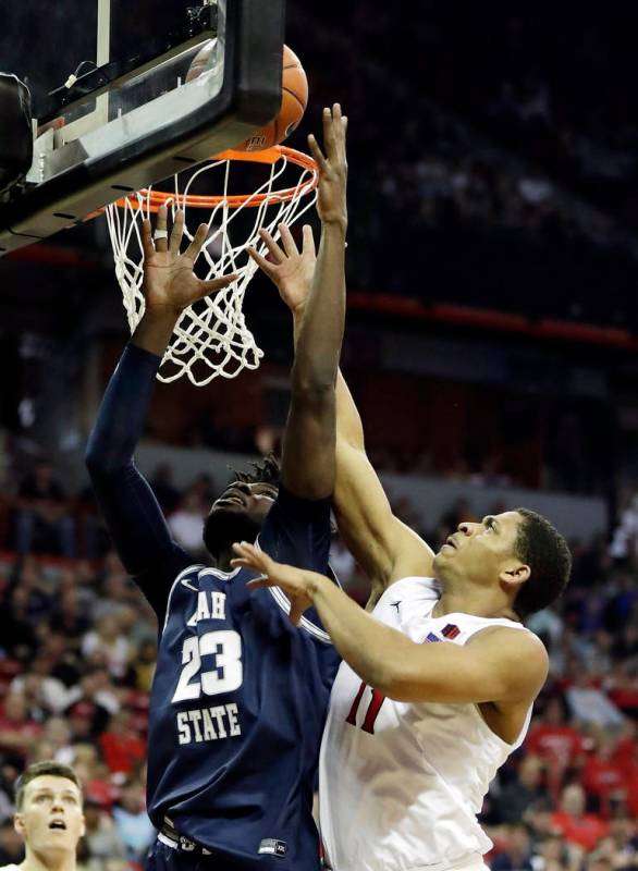 San Diego State's Matt Mitchell (11) and Utah State's Neemias Queta (23) reach for a rebound du ...