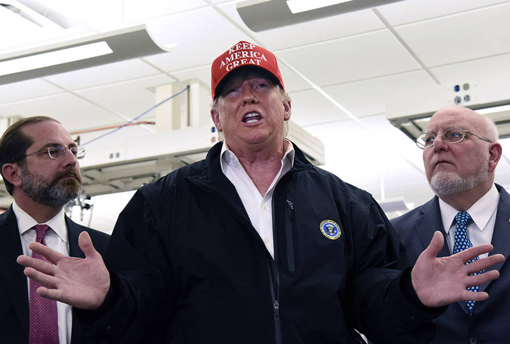 President Donald Trump speaks to members of the press as Health and Human Services Secretary Al ...