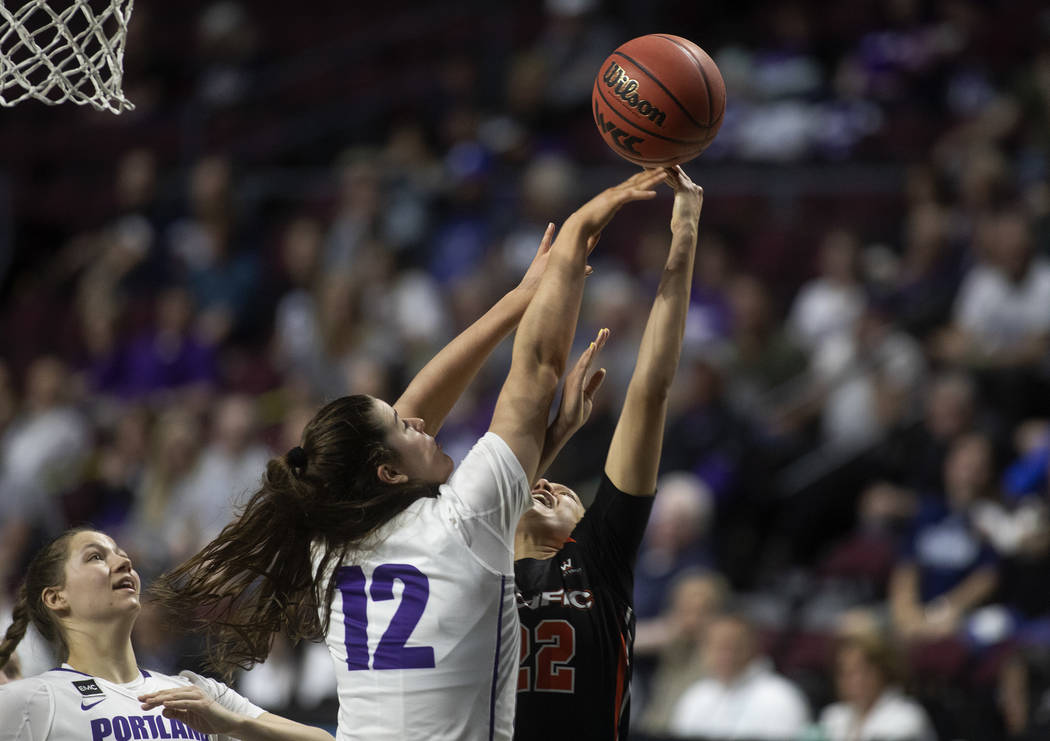 University of Portland's forward Alex Fowler (12) blocks a shot by University of the Pacific's ...