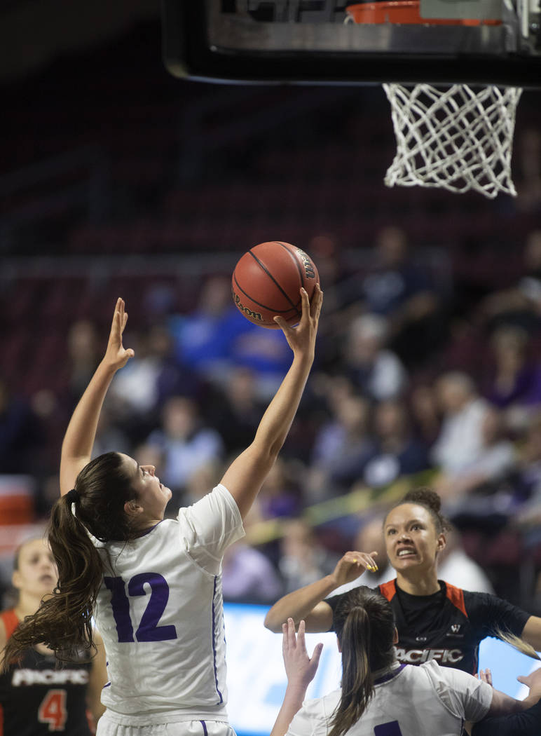 University of Portland's forward Alex Fowler (12) blocks a point from University of the Pacific ...