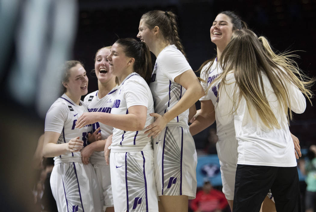 University of Portland women's basketball team celebrates after winning against University of t ...
