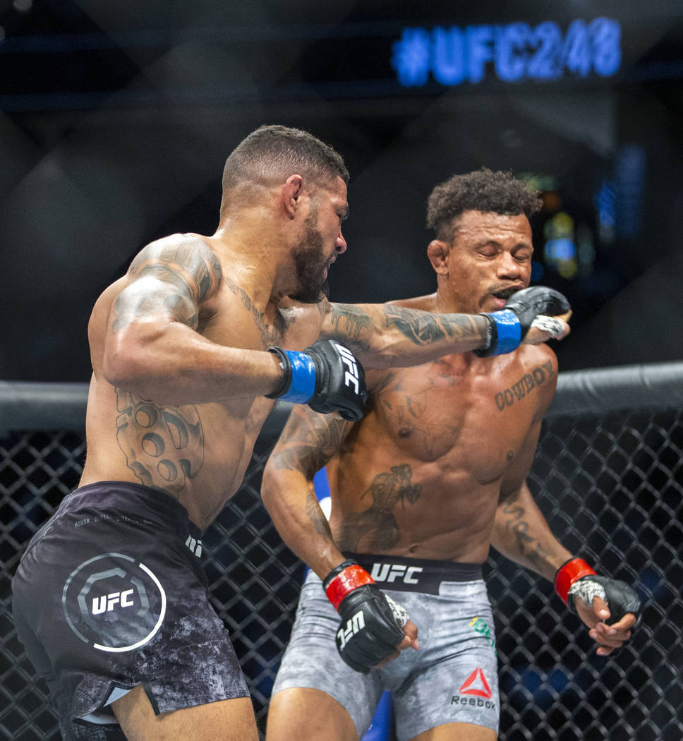 Welterweight Max Griffin, left, connects with a punch to the face of Alex Oliveira during the f ...