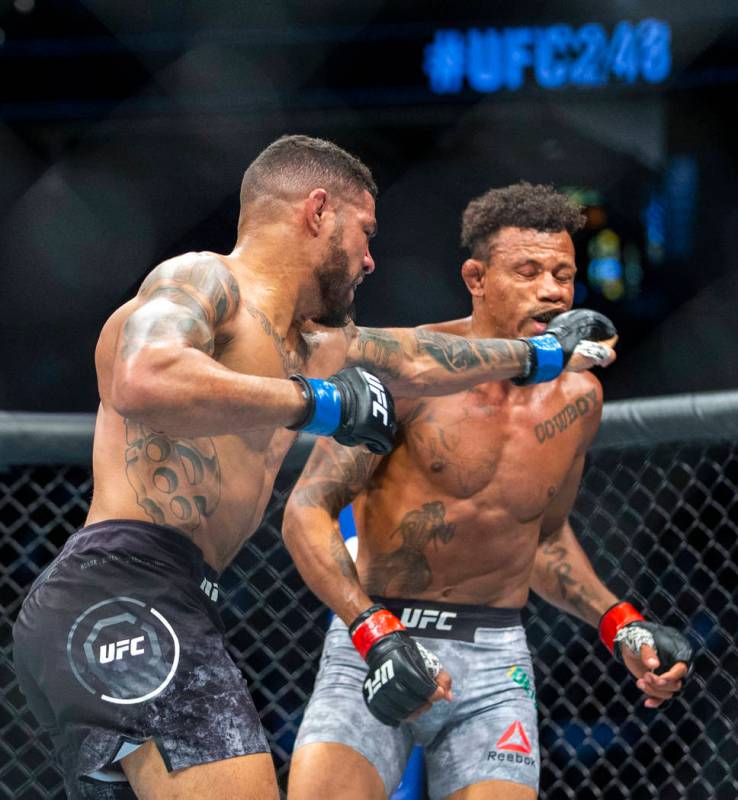 Welterweight Max Griffin, left, connects with a punch to the face of Alex Oliveira during the f ...