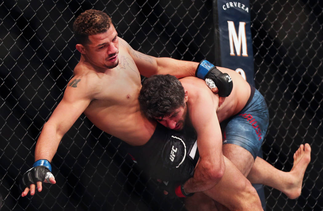 Lightweight Drakkar Klose, left, is taken down by Beneil Dariush during the first round of thei ...