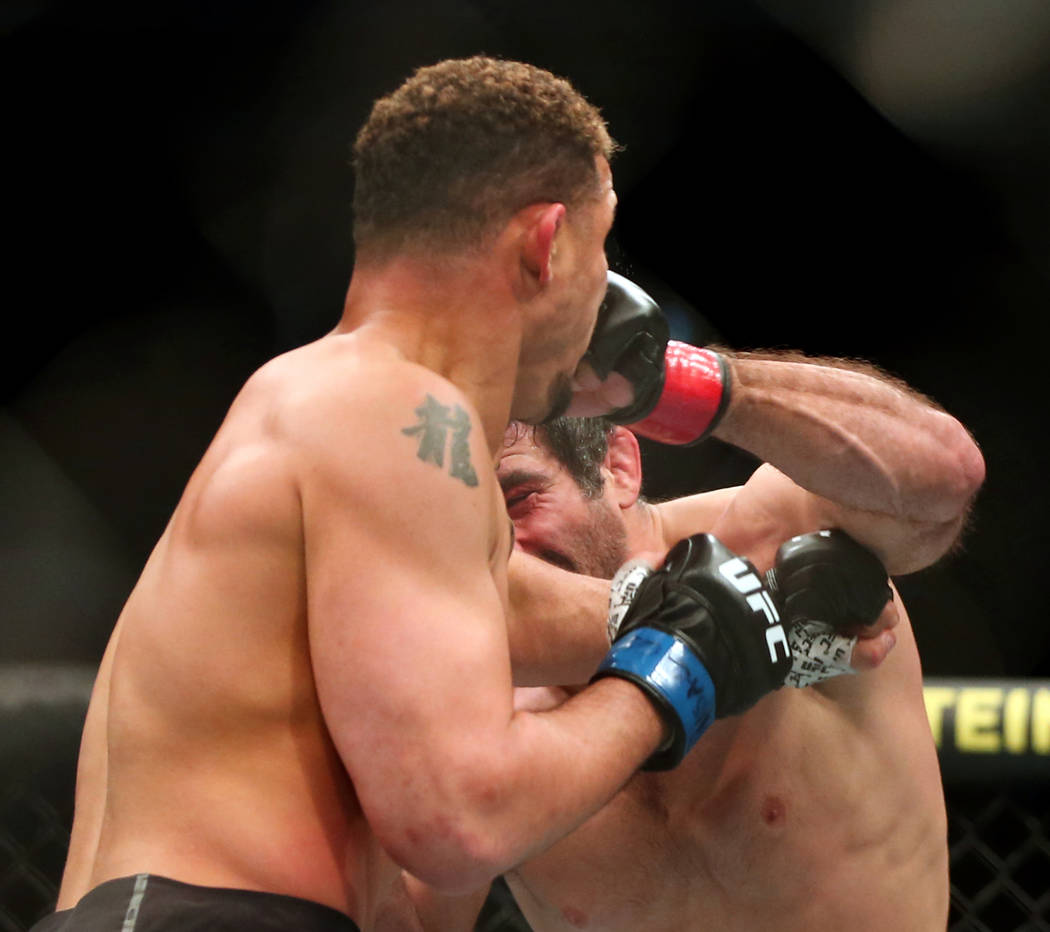 Lightweight Drakkar Klose, left, punched in the face by Beneil Dariush during the second round ...