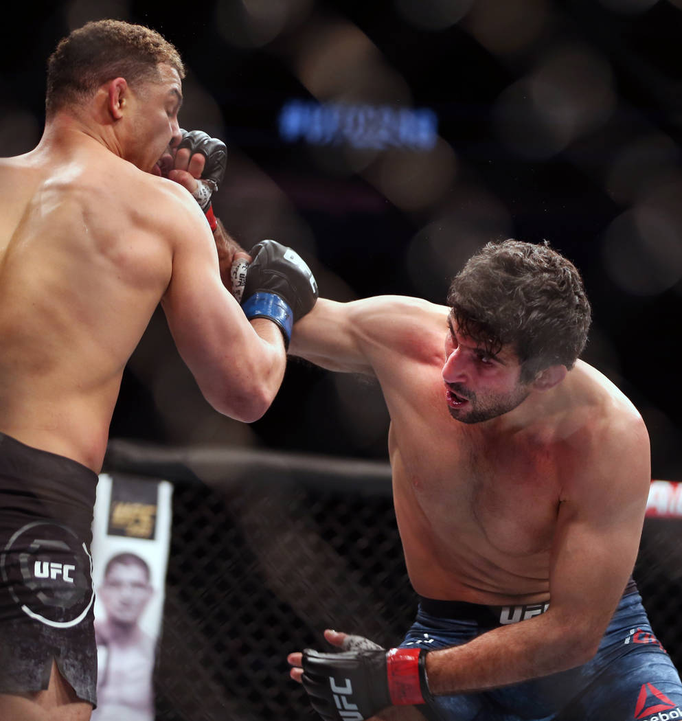 Lightweight Drakkar Klose, left, punched in the face by Beneil Dariush during the second round ...