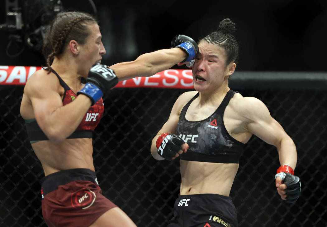 WomenÕs Strawweight Joanna Jedrzejczyk, left, connects on Weili Zhang during the first rou ...