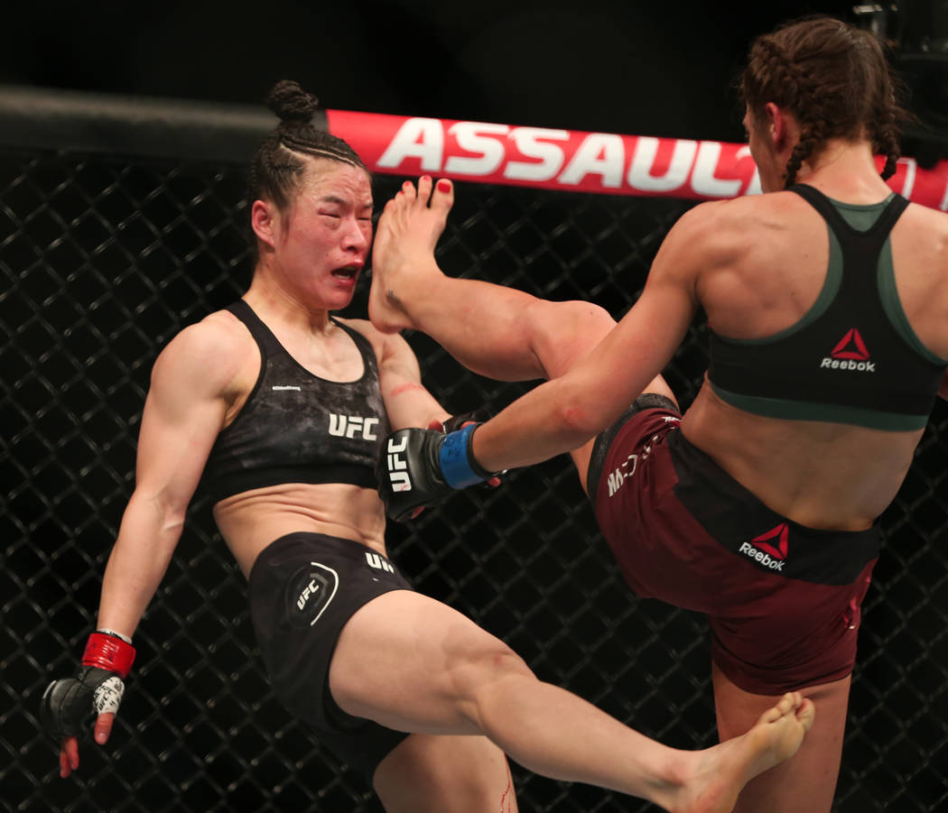 WomenÕs Strawweight Weili Zhang, left, and Joanna Jedrzejczyk trade kicks during the third ...