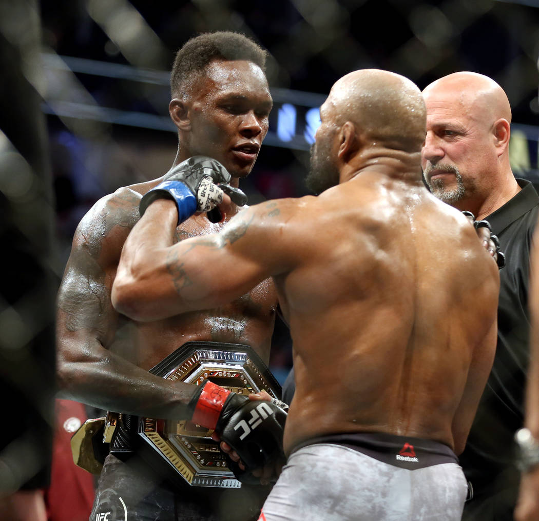 Middleweight Israel Adesanya , left, and Yoel Romero come together after Adesanya is awarded th ...