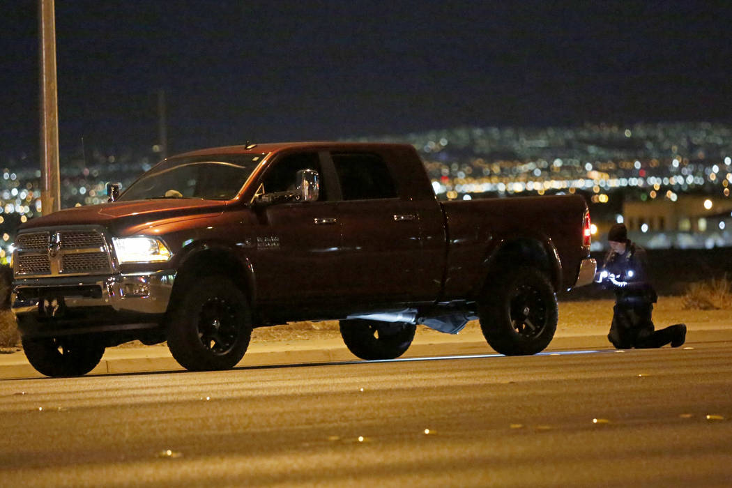 Police investigate a vehicle after a fatal crash near Durango Drive and Twain Avenue in Las Veg ...