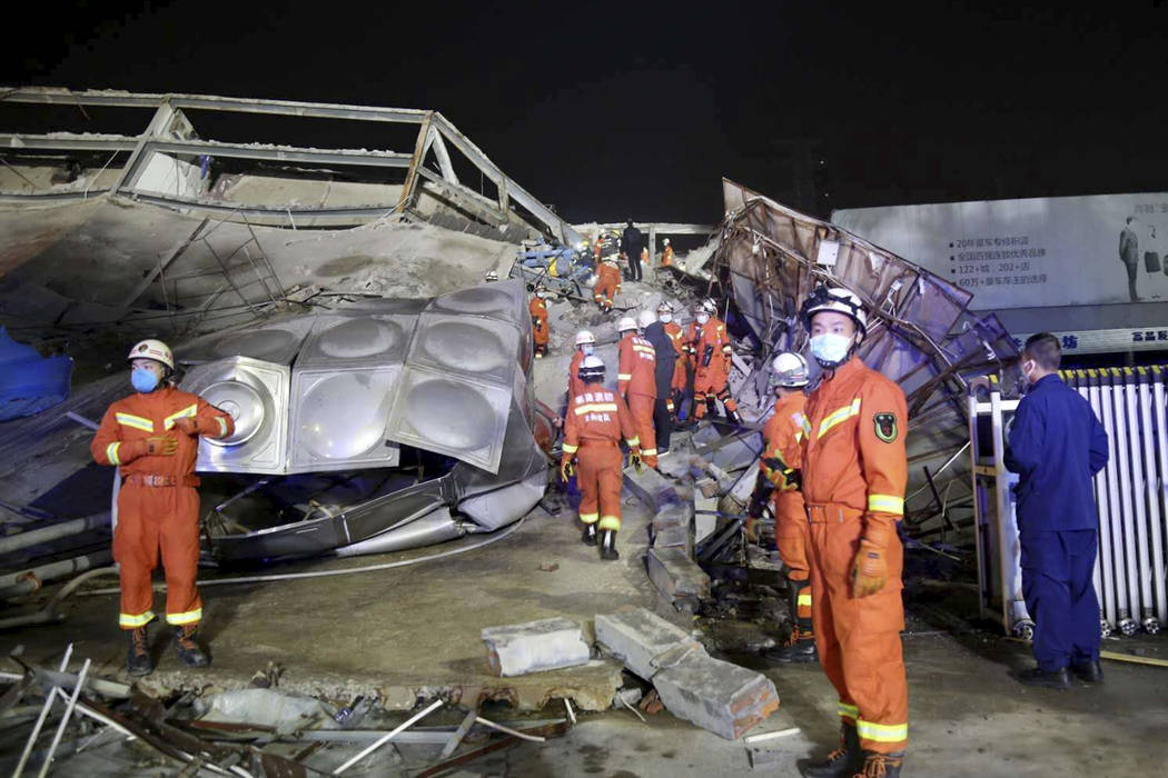 Rescuers work at the site of a collapsed five-story hotel building in Quanzhou city in southeas ...